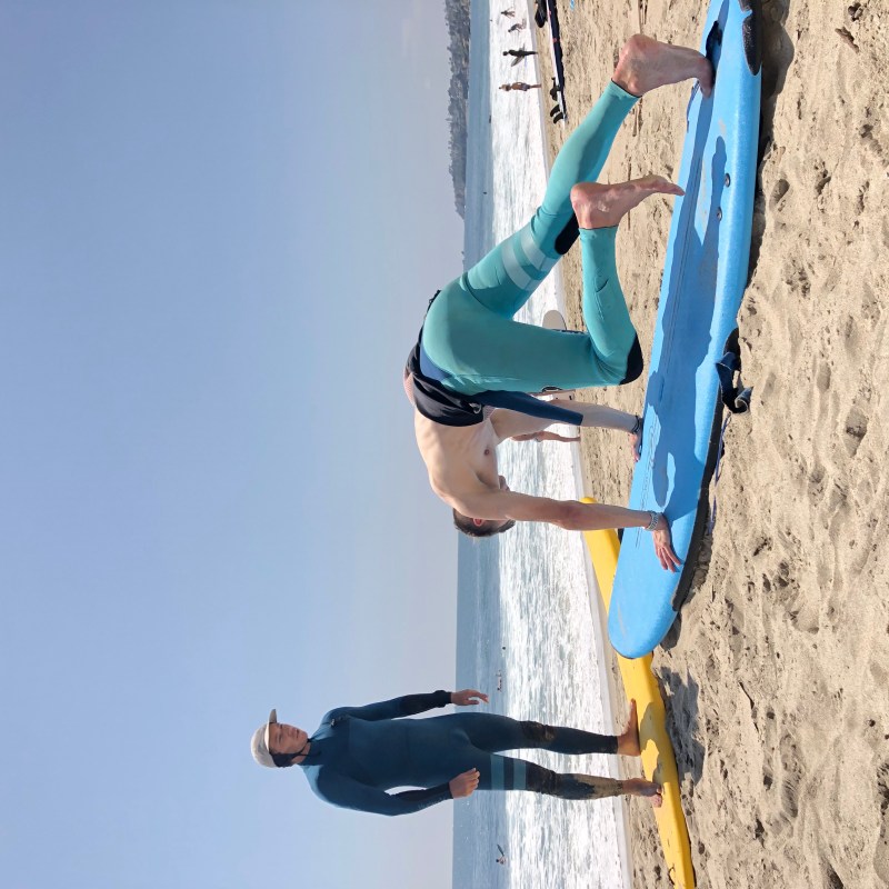 a group of people standing on top of a sandy beach