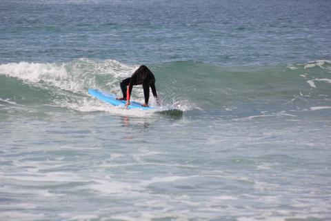a person riding a wave on a surfboard in the water
