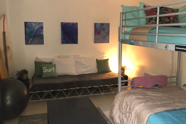 a bedroom with a bed and desk in a room