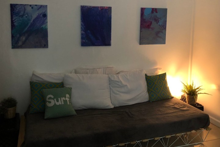 a bedroom with a bed and a painting on the wall