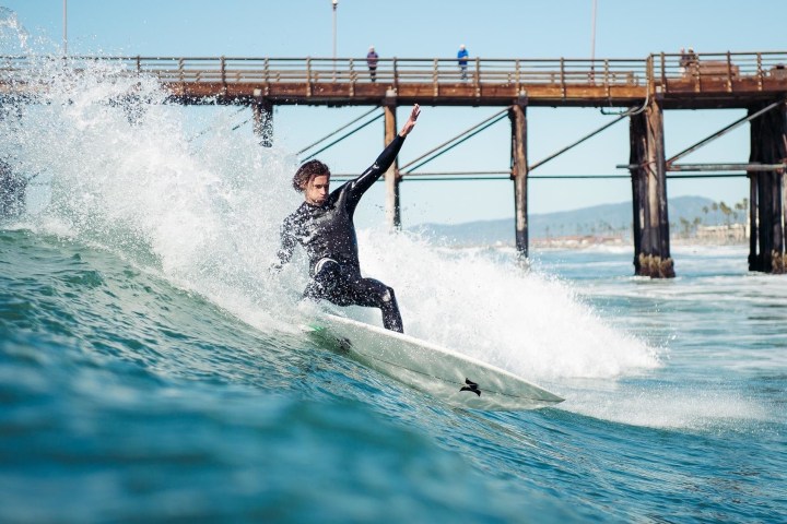 a man riding a wave on top of a body of water