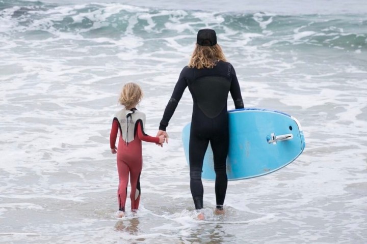 a person standing next to a body of water