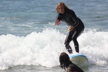 a girl riding a wave on a surfboard in the ocean