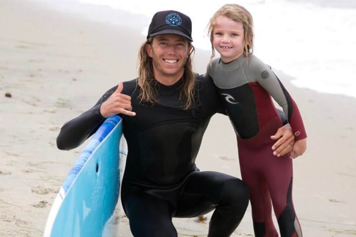a person wearing a wet suit on a beach