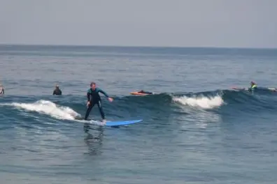 a person riding a wave on a surfboard in the ocean