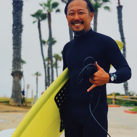 a man carrying a surf board