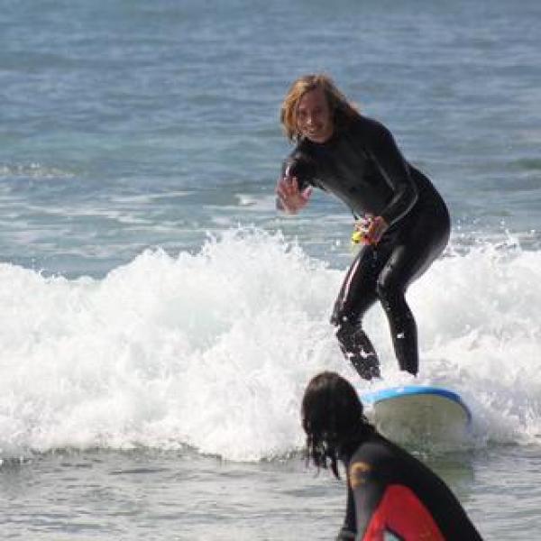 a girl riding a wave on a surfboard in the ocean