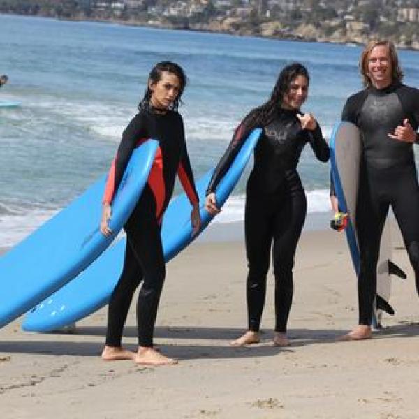 a group of people in a wet suit standing on a beach
