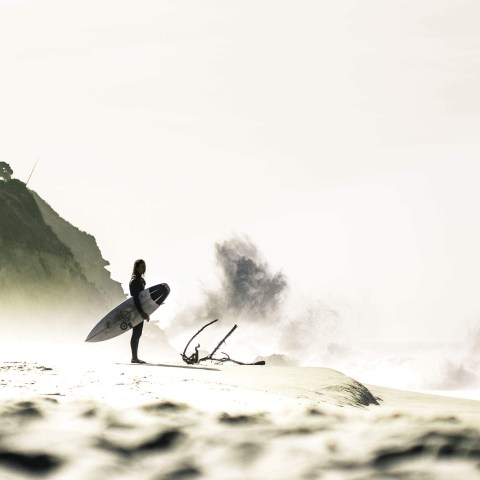 a man riding a wave on a surfboard in the water