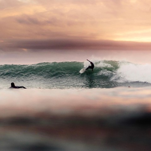 a person riding a wave on a surfboard in the ocean
