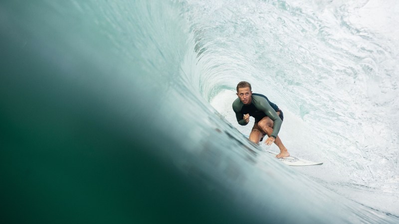 a man riding a wave on a surfboard in the ocean