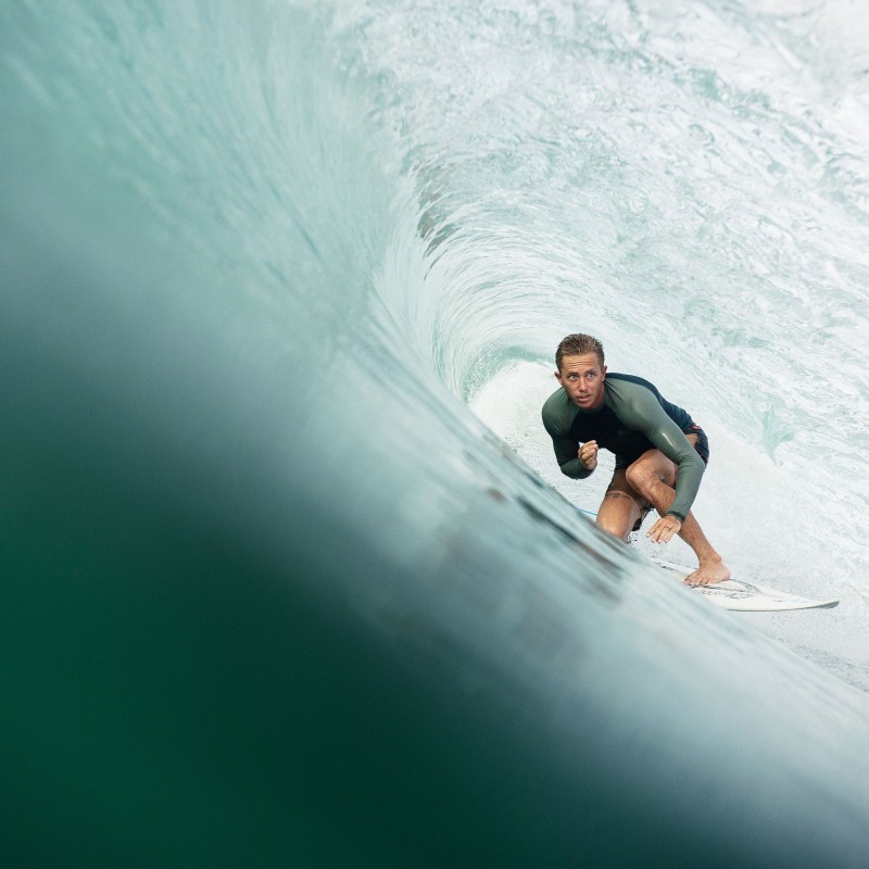 a man riding a wave on a surfboard in the ocean